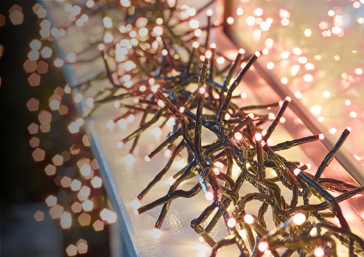 A banner with lit copper glow cluster Christmas lights