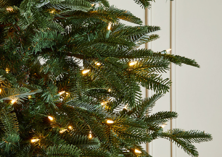 A banner with a lit and decorated christmas tree on