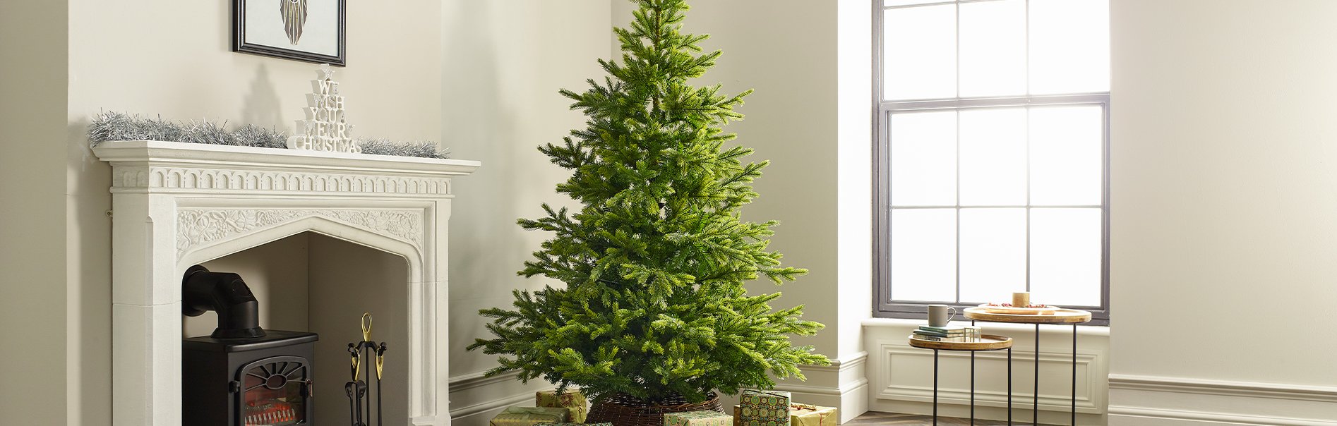 Artificial Christmas tree in a front room with a fire place