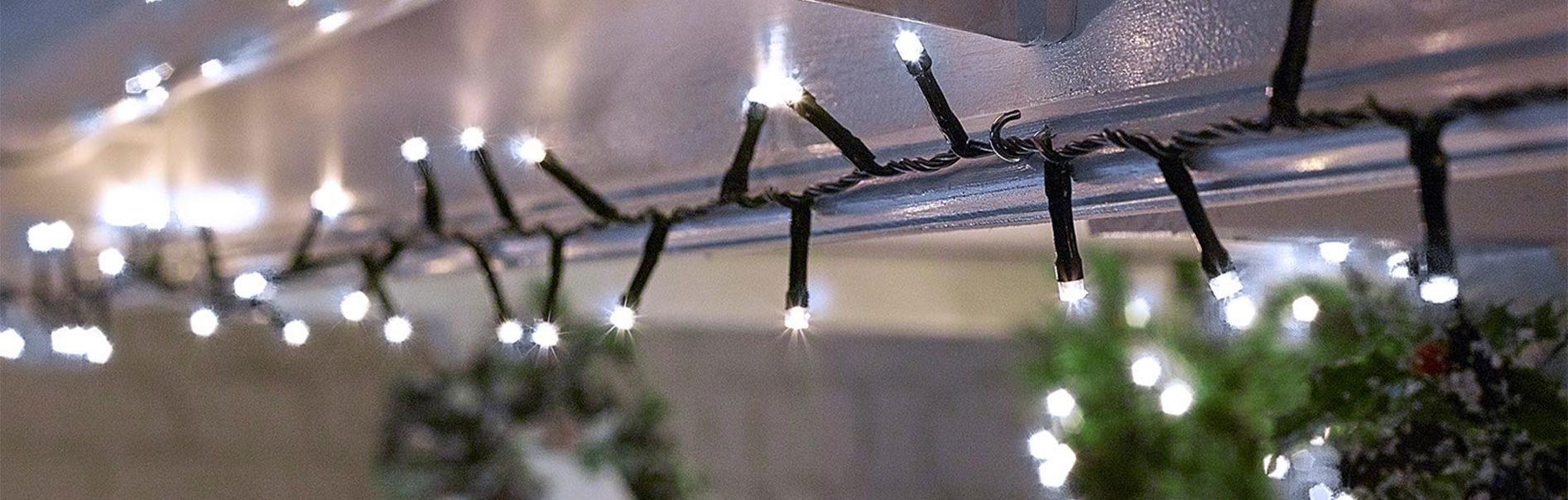 christmas lights hanging on guttering