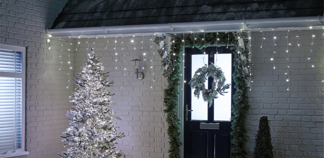 Icicle Christmas Lights Hanging Up Outside The Front Of A House