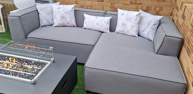 Fabric sofa with cushions and fire pit table