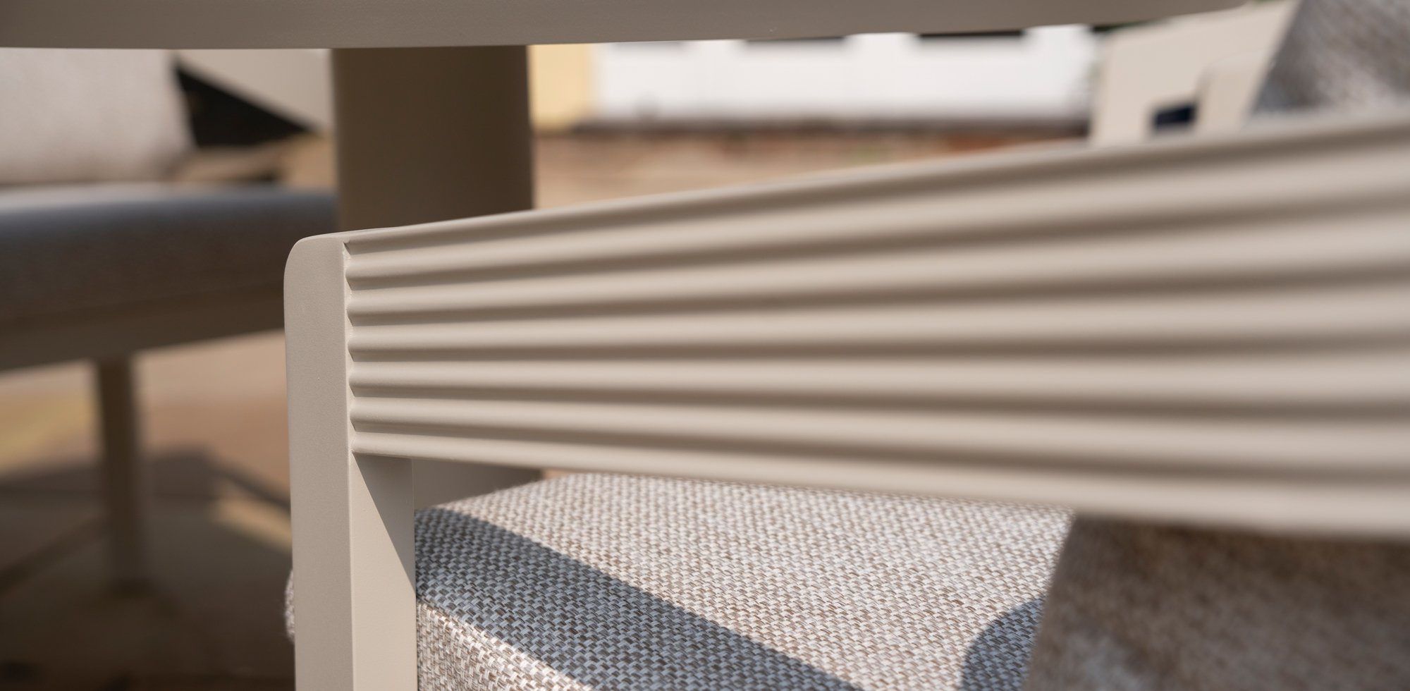 Close up on aluminium dining chair in a pebble colour